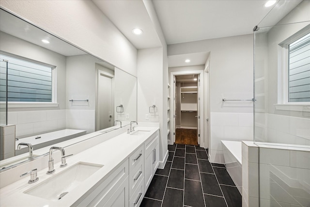 1518 Houston Ave, Houston, TX 77007 - full bathroom featuring a garden tub, double vanity, recessed lighting, a spacious closet, and healthy amount of natural light