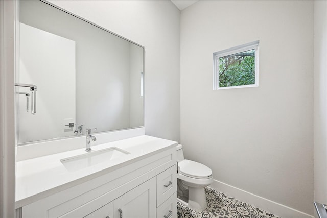 1518 Houston Ave, Houston, TX 77007 - half bathroom with toilet, vanity, tile patterned flooring, and baseboards