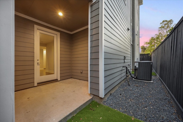 1518 Houston Ave, Houston, TX 77007 - exterior entry at dusk with central air condition unit and a patio area