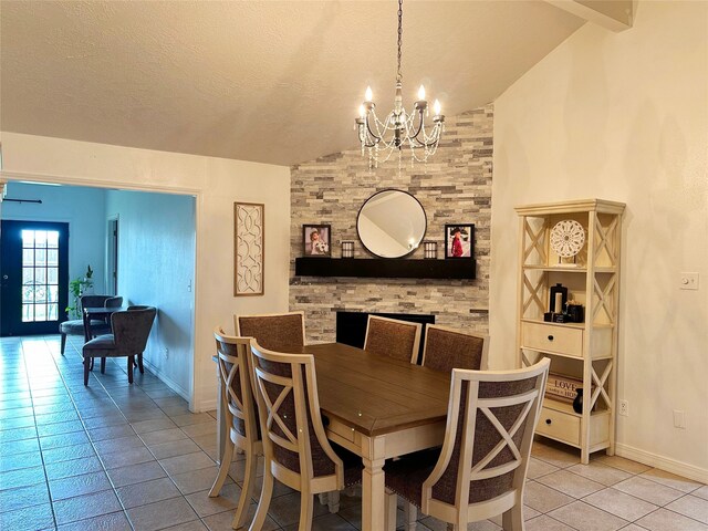 117 Lasso St, Angleton, TX 77515 - dining space with lofted ceiling, light tile patterned floors, a chandelier, baseboards, and a textured ceiling