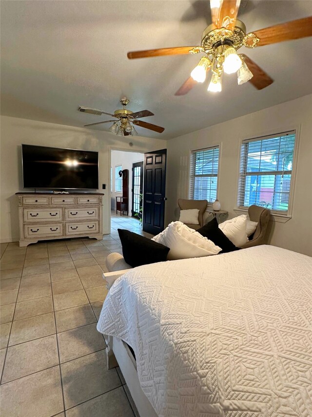 117 Lasso St, Angleton, TX 77515 - bedroom with light tile patterned flooring and a ceiling fan