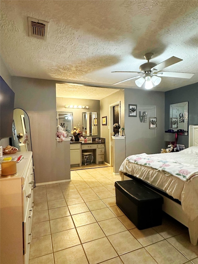 117 Lasso St, Angleton, TX 77515 - bedroom with light tile patterned floors, a textured ceiling, ceiling fan, and baseboards