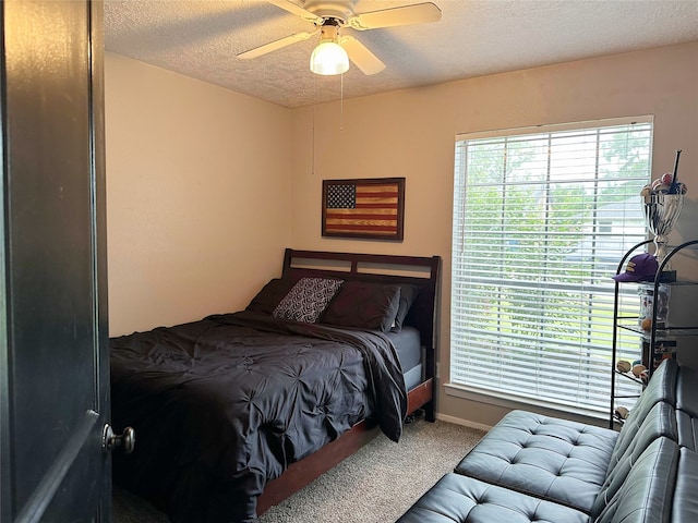 117 Lasso St, Angleton, TX 77515 - bedroom featuring carpet floors, a textured ceiling, multiple windows, a ceiling fan, and baseboards