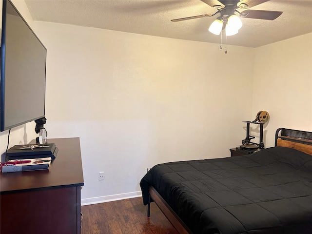 117 Lasso St, Angleton, TX 77515 - bedroom featuring dark wood-type flooring, baseboards, a ceiling fan, and a textured ceiling