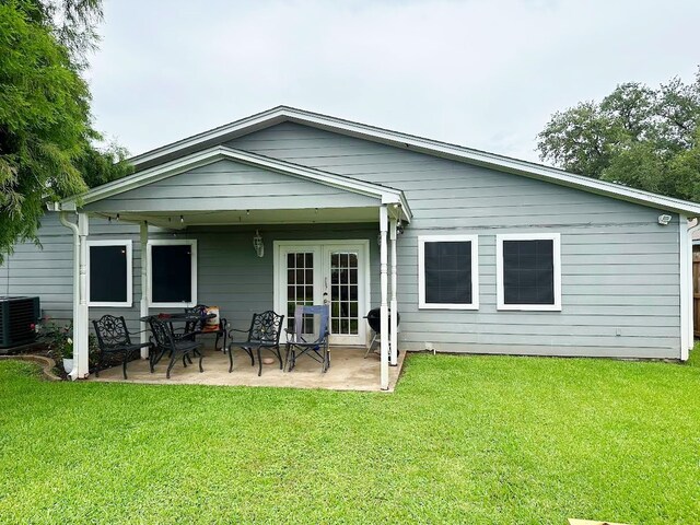 117 Lasso St, Angleton, TX 77515 - back of property with french doors, a patio area, central air condition unit, and a yard
