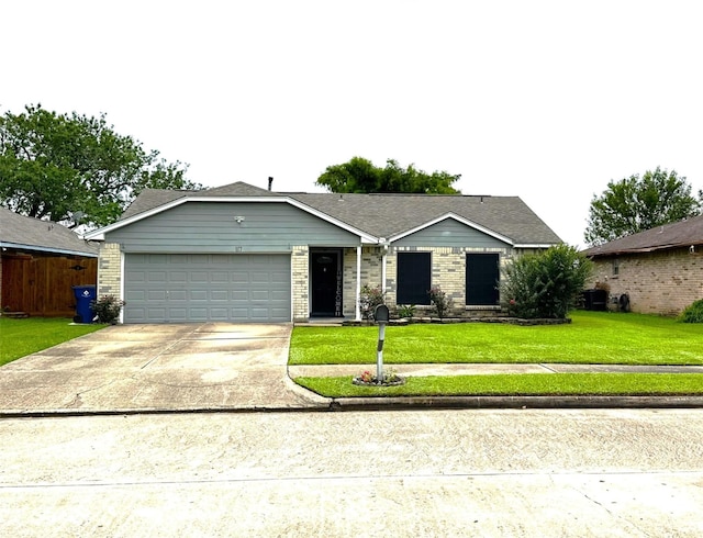 117 Lasso St, Angleton, TX 77515 - ranch-style house featuring a garage, a front lawn, and driveway