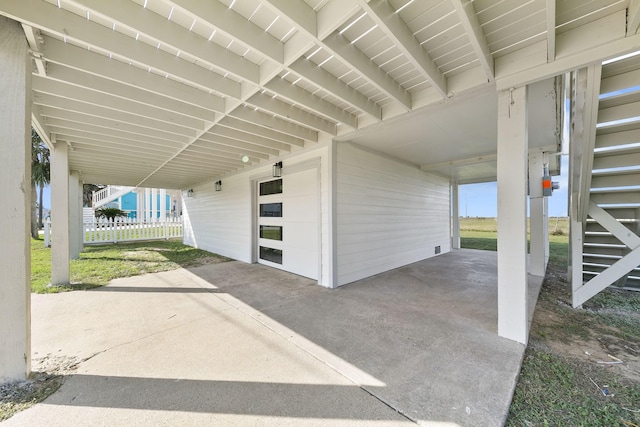 13014 John Reynolds Rd, Galveston, TX 77554 - view of patio with a carport and a garage