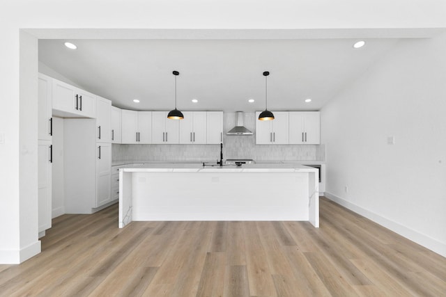13014 John Reynolds Rd, Galveston, TX 77554 - kitchen with wall chimney exhaust hood, light countertops, decorative backsplash, white cabinetry, and recessed lighting