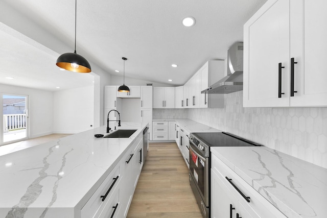 13014 John Reynolds Rd, Galveston, TX 77554 - kitchen with a sink, stainless steel appliances, wall chimney range hood, backsplash, and light wood finished floors