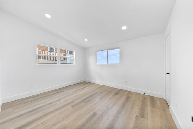 13014 John Reynolds Rd, Galveston, TX 77554 - spare room featuring light wood-style flooring, lofted ceiling, recessed lighting, and baseboards