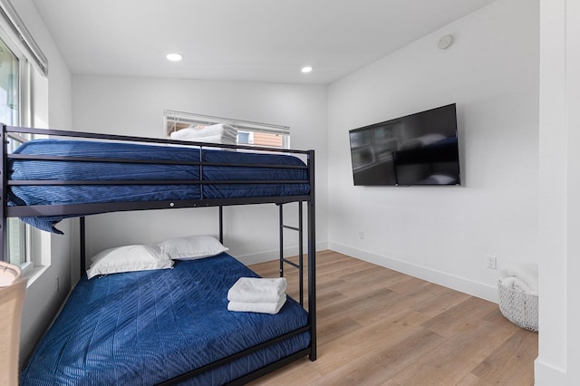 13014 John Reynolds Rd, Galveston, TX 77554 - bedroom featuring multiple windows, wood finished floors, recessed lighting, and baseboards