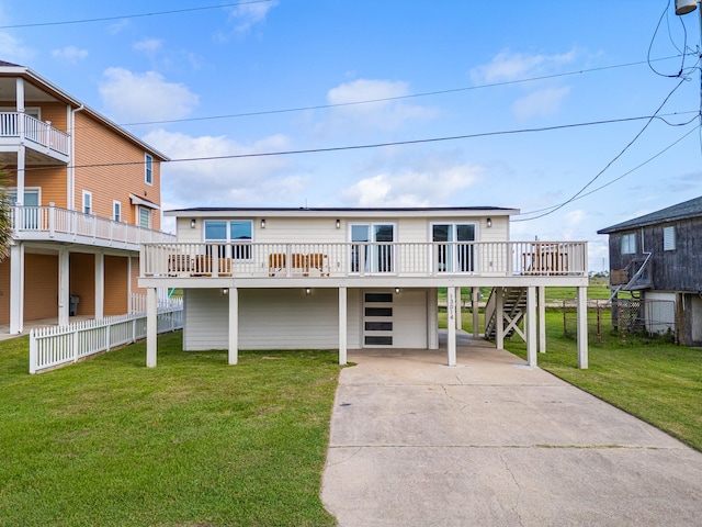 13014 John Reynolds Rd, Galveston, TX 77554 - raised beach house with an attached garage, driveway, a front lawn, stairway, and a wooden deck