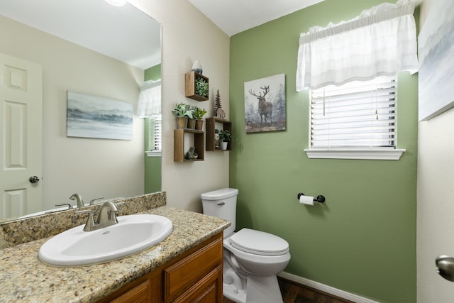 2310 Willow Bend Dr, Richmond, TX 77406 - bathroom with toilet, vanity, wood finished floors, and baseboards