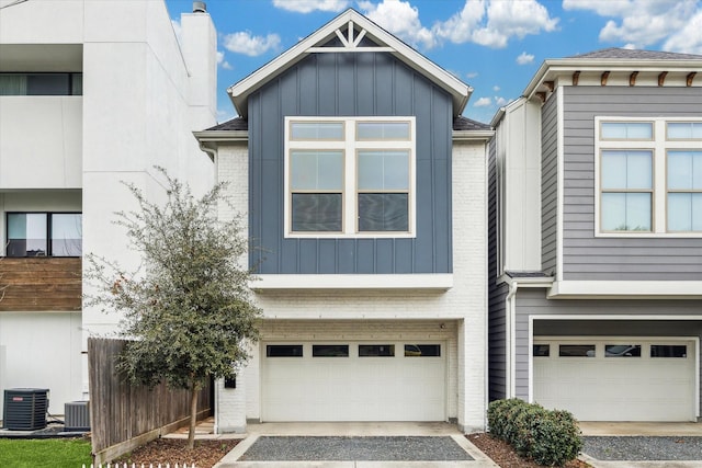 706 Olive St Unit B, Houston, TX 77007 - view of front of home featuring an attached garage, brick siding, board and batten siding, and driveway