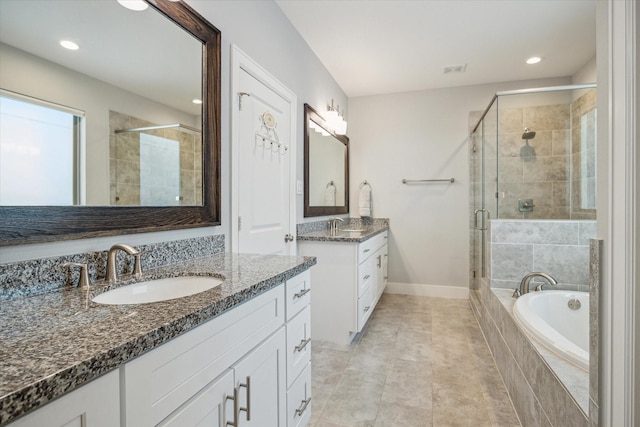 706 Olive St Unit B, Houston, TX 77007 - full bath with a stall shower, two vanities, a garden tub, recessed lighting, and baseboards