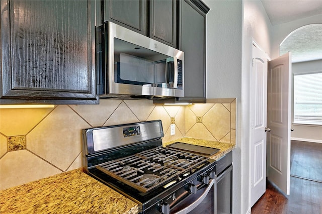 20610 Arrow Falls Ln, Richmond, TX 77407 - kitchen featuring appliances with stainless steel finishes, tasteful backsplash, dark wood-type flooring, and baseboards