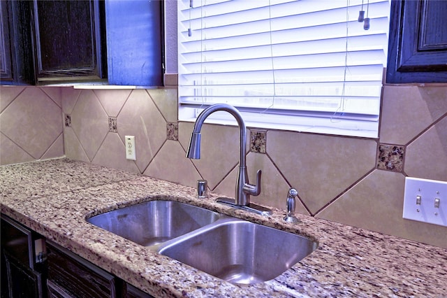 20610 Arrow Falls Ln, Richmond, TX 77407 - kitchen view of a sink, backsplash, and light stone countertops