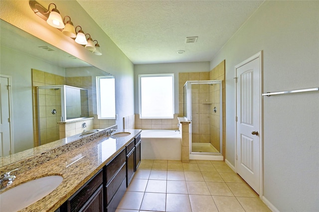 20610 Arrow Falls Ln, Richmond, TX 77407 - full bath with a stall shower, a bath, double vanity, tile patterned floors, and a textured ceiling