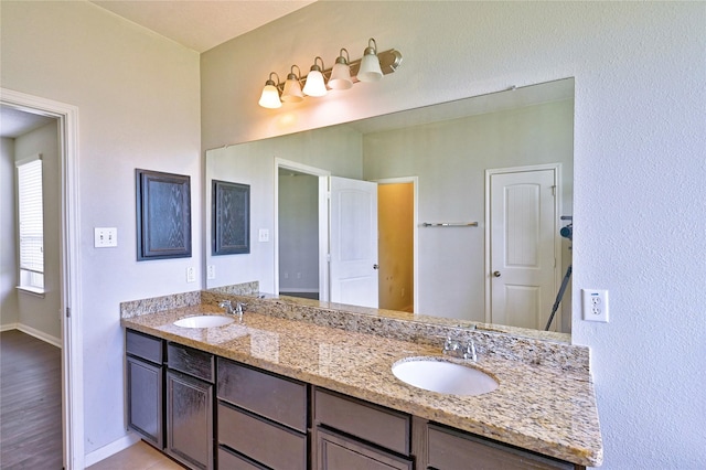 20610 Arrow Falls Ln, Richmond, TX 77407 - bathroom featuring baseboards and double vanity
