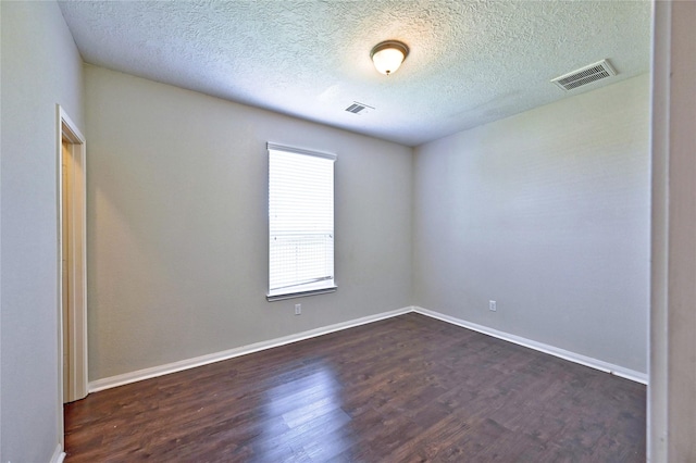 20610 Arrow Falls Ln, Richmond, TX 77407 - empty room featuring dark wood-style flooring, a textured ceiling, and baseboards
