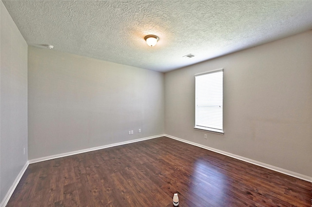 20610 Arrow Falls Ln, Richmond, TX 77407 - empty room featuring dark wood-type flooring, baseboards, and a textured ceiling