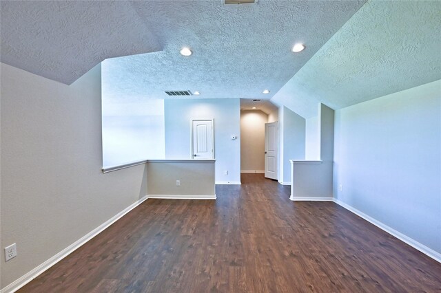 20610 Arrow Falls Ln, Richmond, TX 77407 - spare room with dark wood finished floors, baseboards, a textured ceiling, recessed lighting, and vaulted ceiling