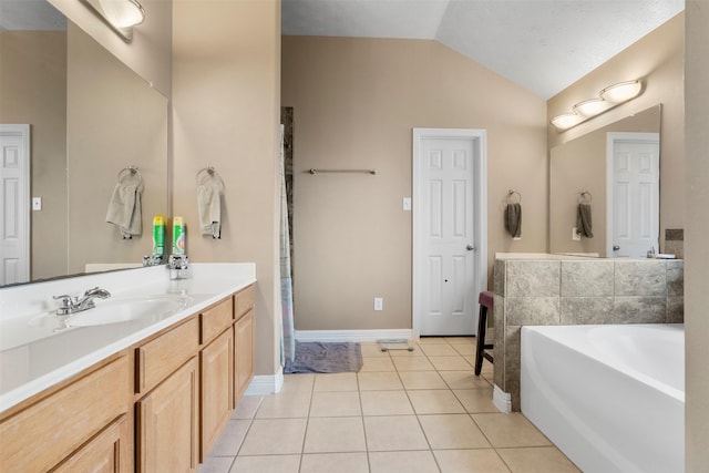 1814 Caroline Ave, Baytown, TX 77523 - bathroom featuring lofted ceiling, a garden tub, vanity, tile patterned flooring, and baseboards