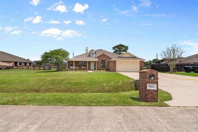 1814 Caroline Ave, Baytown, TX 77523 - view of front of property with driveway, brick siding, a garage, a chimney, and roof with shingles