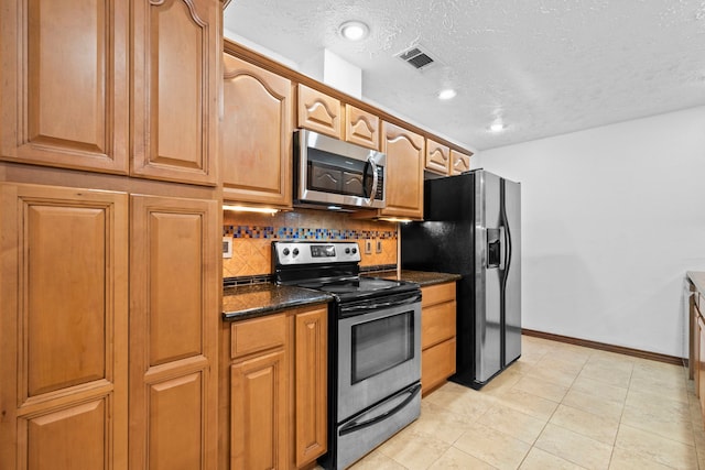 10507 Stockman Ln, Sugar Land, TX 77498 - kitchen featuring stainless steel appliances, baseboards, tasteful backsplash, a textured ceiling, and brown cabinetry