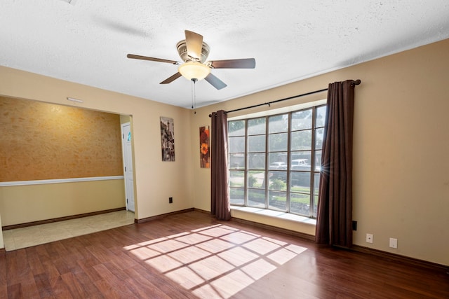 10507 Stockman Ln, Sugar Land, TX 77498 - empty room featuring wood finished floors, baseboards, ceiling fan, and a textured ceiling