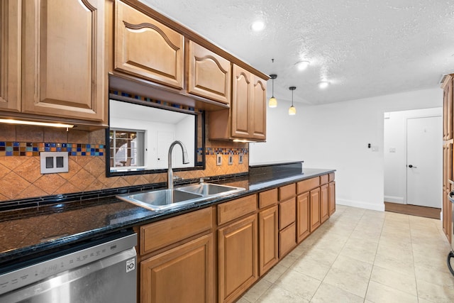 10507 Stockman Ln, Sugar Land, TX 77498 - kitchen featuring stainless steel dishwasher, a sink, tasteful backsplash, a textured ceiling, and baseboards