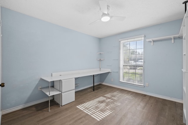 10507 Stockman Ln, Sugar Land, TX 77498 - unfurnished office featuring wood finished floors, a ceiling fan, baseboards, and a textured ceiling