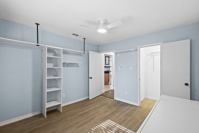 10507 Stockman Ln, Sugar Land, TX 77498 - unfurnished bedroom with wood finished floors, baseboards, and a ceiling fan