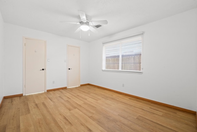 10507 Stockman Ln, Sugar Land, TX 77498 - spare room featuring baseboards, light wood finished floors, and a ceiling fan