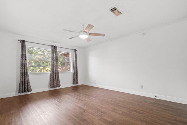 10507 Stockman Ln, Sugar Land, TX 77498 - spare room featuring dark wood-style floors, baseboards, ceiling fan, and ornamental molding