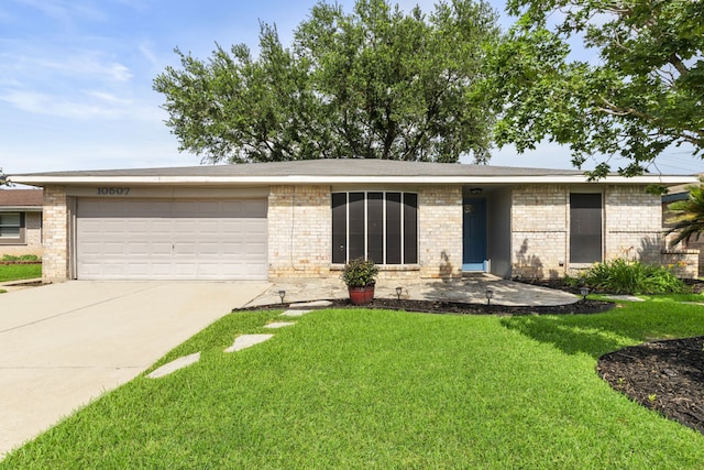10507 Stockman Ln, Sugar Land, TX 77498 - view of front of property featuring concrete driveway, a garage, a front lawn, and brick siding