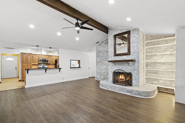 10507 Stockman Ln, Sugar Land, TX 77498 - unfurnished living room with ceiling fan, wood finished floors, a brick fireplace, baseboards, and recessed lighting