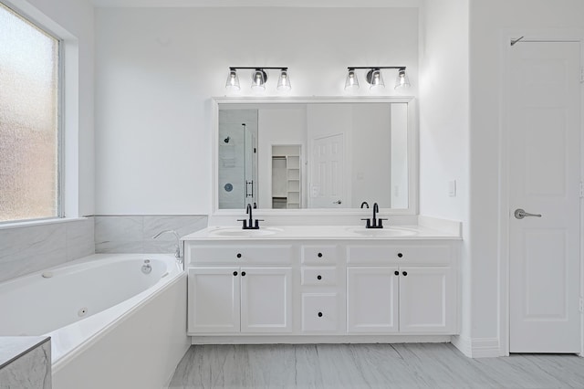 21357 Thurston Crossing Dr, Porter, TX 77365 - full bathroom featuring a shower stall, double vanity, a jetted tub, and marble finish flooring