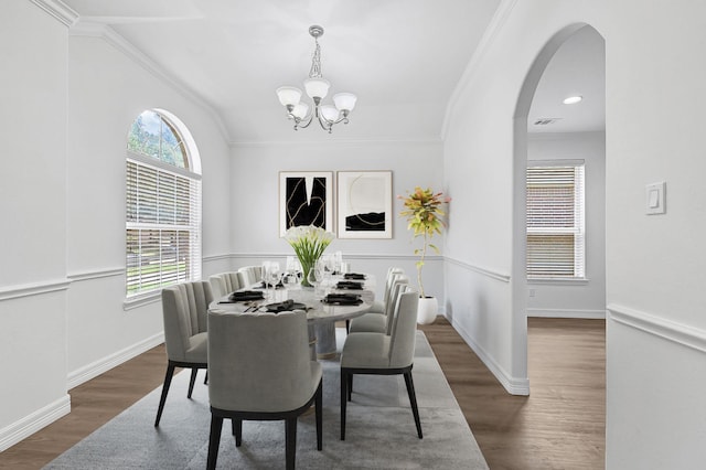 21357 Thurston Crossing Dr, Porter, TX 77365 - dining space featuring a chandelier, crown molding, wood finished floors, arched walkways, and baseboards