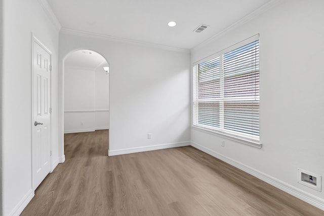 21357 Thurston Crossing Dr, Porter, TX 77365 - spare room with ornamental molding, light wood-type flooring, arched walkways, baseboards, and recessed lighting