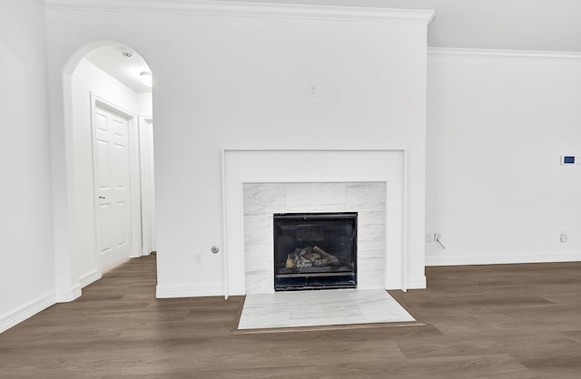 21357 Thurston Crossing Dr, Porter, TX 77365 - detailed view of wood finished floors, crown molding, arched walkways, baseboards, and a tile fireplace