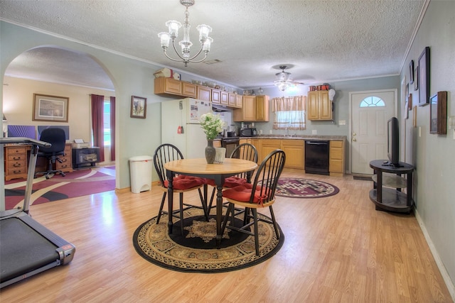 712 E Morris St, Madisonville, TX 77864 - dining space featuring arched walkways, a textured ceiling, light wood-style floors, a ceiling fan, and ornamental molding