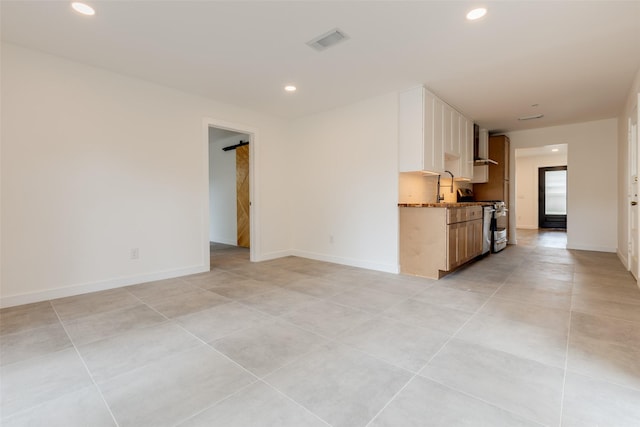 1730 Wakefield Dr, Houston, TX 77018 - unfurnished living room featuring recessed lighting, light tile patterned flooring, and baseboards
