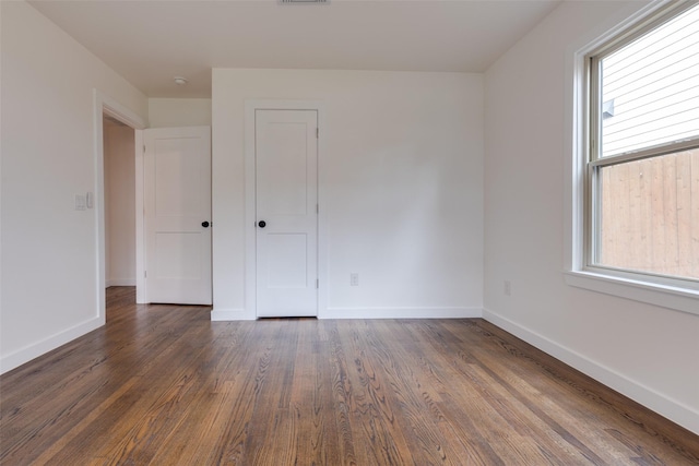 1730 Wakefield Dr, Houston, TX 77018 - spare room featuring baseboards and dark wood-type flooring