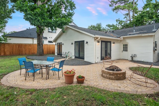 1730 Wakefield Dr, Houston, TX 77018 - back of property featuring french doors, a fire pit, a patio, and a shingled roof