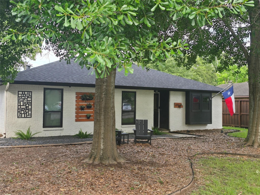 211 S Poplar St, Tomball, TX 77375 - view of front of property featuring a shingled roof and brick siding