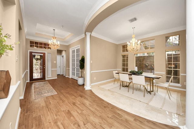 1542 Orchard Park Dr, Houston, TX 77077 - foyer entrance featuring a chandelier, ornamental molding, a tray ceiling, wood finished floors, and arched walkways