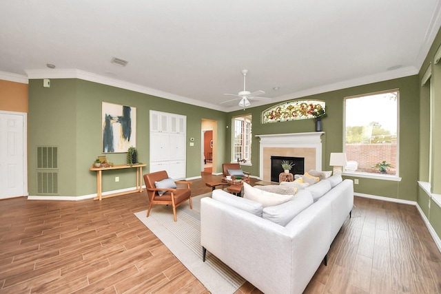 1542 Orchard Park Dr, Houston, TX 77077 - living room with a fireplace, wood finished floors, baseboards, ceiling fan, and ornamental molding