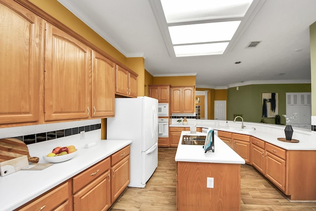 1542 Orchard Park Dr, Houston, TX 77077 - kitchen featuring white appliances, a sink, a center island, light wood-style floors, and ornamental molding