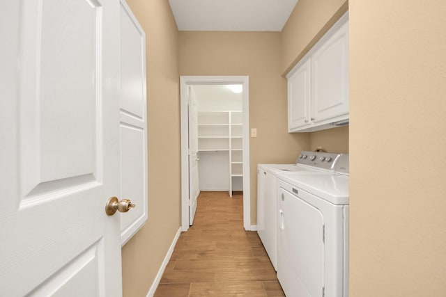 1542 Orchard Park Dr, Houston, TX 77077 - laundry area with washing machine and dryer, cabinet space, light wood-style floors, and baseboards